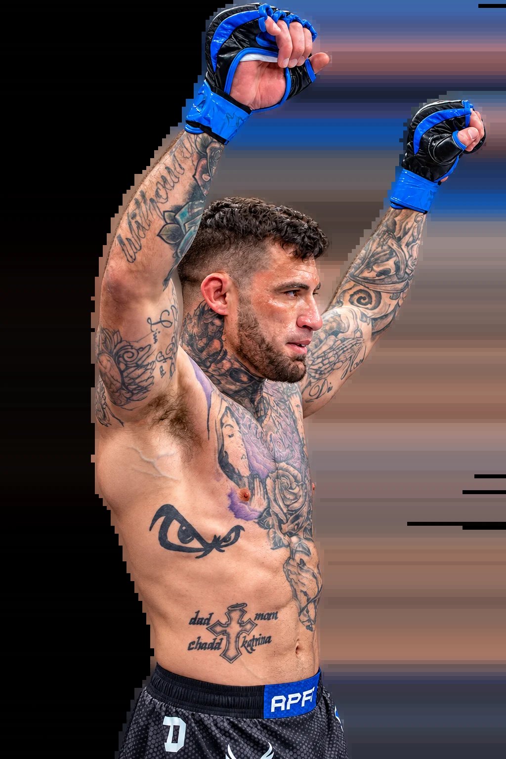 Tattooed MMA fighter with blue gloves celebrating victory with both arms raised above head against black background