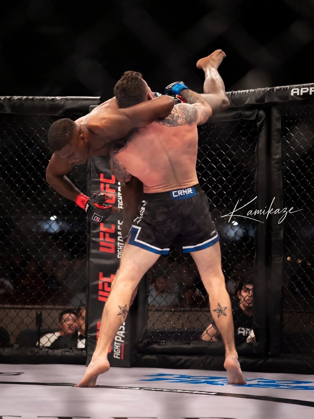 Two MMA fighters exchanging strikes in a UFC octagon during a professional bout